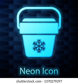 Glowing neon Cooler bag icon isolated on brick wall background. Portable freezer bag. Handheld refrigerator. Vector Illustration