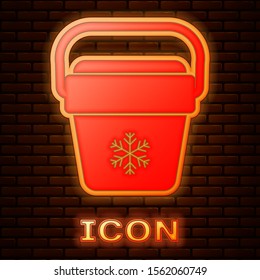 Glowing neon Cooler bag icon isolated on brick wall background. Portable freezer bag. Handheld refrigerator.  Vector Illustration