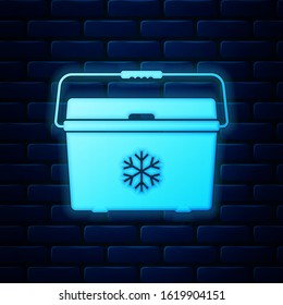 Glowing neon Cooler bag icon isolated on brick wall background. Portable freezer bag. Handheld refrigerator.  Vector Illustration