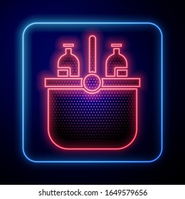 Glowing neon Cooler bag and water icon isolated on blue background. Portable freezer bag. Handheld refrigerator.  Vector Illustration