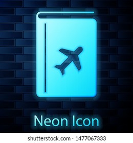 Glowing neon Cover book travel guide icon isolated on brick wall background.  Vector Illustration