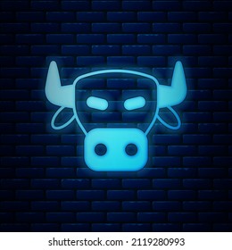 Glowing neon Cow head icon isolated on brick wall background.  Vector