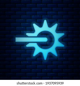 Glowing neon Cowboy horse riding spur for boot icon isolated on brick wall background.  Vector