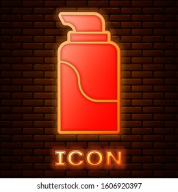 Glowing neon Cream or lotion cosmetic tube icon isolated on brick wall background. Body care products for men.  Vector Illustration