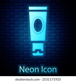 Glowing neon Cream or lotion cosmetic tube icon isolated on brick wall background. Body care products for woman.  Vector
