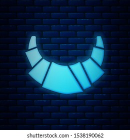 Glowing neon Croissant icon isolated on brick wall background.  Vector Illustration