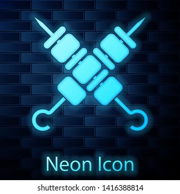 Glowing neon Crossed grilled shish kebab on skewers stick icon isolated on brick wall background. Meat kebab on skewers stick. Picnic with grill meat. Vector Illustration