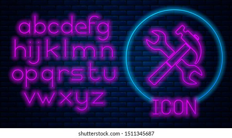 Glowing neon Crossed hammer and wrench icon isolated on brick wall background. Hardware tools. Neon light alphabet. Vector Illustration