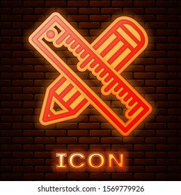 Glowing neon Crossed ruler and pencil icon isolated on brick wall background. Straightedge symbol. Drawing and educational tools.  Vector Illustration