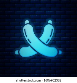 Glowing neon Crossed sausage icon isolated on brick wall background. Grilled sausage and aroma sign.  Vector Illustration
