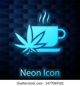 Glowing neon Cup tea with marijuana or cannabis leaf icon isolated on brick wall background. Marijuana legalization. Hemp symbol.  Vector Illustration