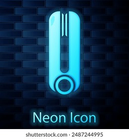 Glowing neon Curling iron for hair icon isolated on brick wall background. Hair straightener icon.  Vector Illustration
