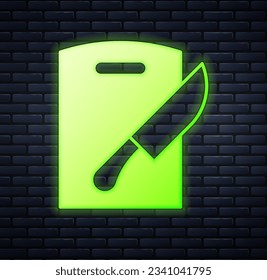 Glowing neon Cutting board and knife icon isolated on brick wall background. Chopping Board symbol. Cutlery symbol.  Vector