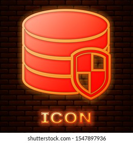 Glowing neon Database protection icon isolated on brick wall background. Secure database icon.  Vector Illustration