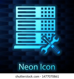 Glowing neon Database server with screwdriver and wrench icon isolated on brick wall background. Adjusting, service, setting, maintenance, repair, fixing.  Vector Illustration