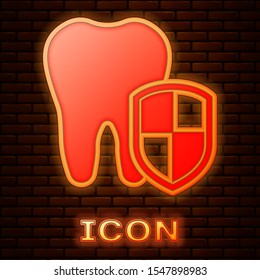 Glowing neon Dental protection icon isolated on brick wall background. Tooth on shield logo.  Vector Illustration