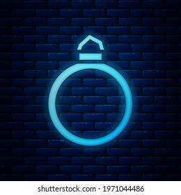 Glowing neon Diamond engagement ring icon isolated on brick wall background.  Vector