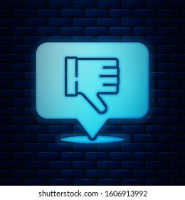 Glowing neon Dislike in speech bubble icon isolated on brick wall background.  Vector Illustration