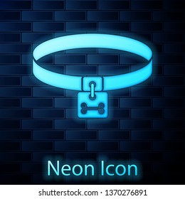 Glowing neon Dog collar with name tag and bone plaque icon isolated on brick wall background. Supplies for domestic animal. Cat and dog care. Pet dog chains. Vector Illustration