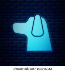 Glowing neon Dog icon isolated on brick wall background.  Vector Illustration