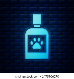 Glowing neon Dog medicine bottle icon isolated on brick wall background. Container with pills. Prescription medicine for animal.  Vector Illustration