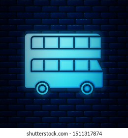 Glowing neon Double decker bus icon isolated on brick wall background. London classic passenger bus. Public transportation symbol.  Vector Illustration