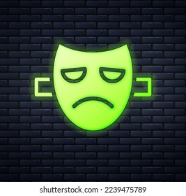 Glowing neon Drama theatrical mask icon isolated on brick wall background.  Vector