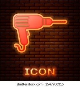 Glowing neon Drill machine icon isolated on brick wall background.  Vector Illustration