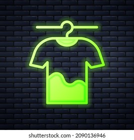 Glowing neon Drying clothes icon isolated on brick wall background. Clean shirt. Wash clothes on a rope with clothespins. Clothing care and tidiness.  Vector