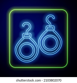 Glowing neon Earrings icon isolated on blue background. Jewelry accessories.  Vector