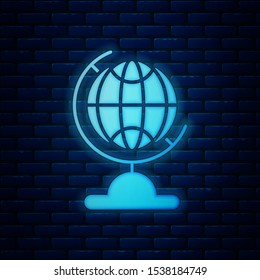 Glowing neon Earth globe icon isolated on brick wall background.  Vector Illustration