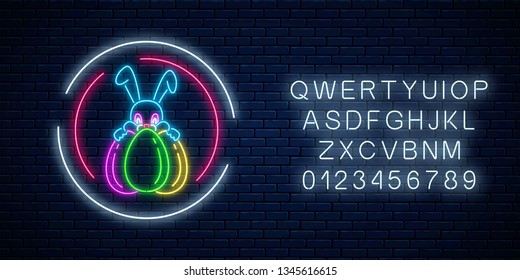 Glowing neon easter bunny with eggs sign in circle frames with alphabet on dark brick wall background. Night greeting banner with easter rabbit. Vector illustration.