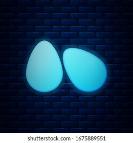 Glowing neon Easter eggs icon isolated on brick wall background. Happy Easter.  Vector Illustration