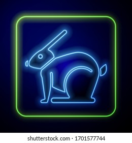 Glowing neon Easter rabbit icon isolated on blue background. Easter Bunny.  Vector Illustration