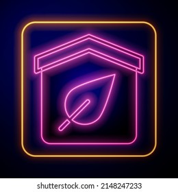 Glowing neon Eco friendly house icon isolated on black background. Eco house with leaf.  Vector