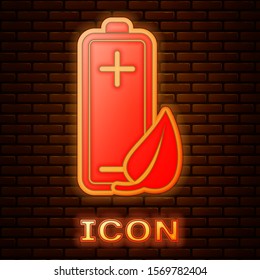 Glowing neon Eco nature leaf and battery icon isolated on brick wall background. Energy based on ecology saving concept.  Vector Illustration
