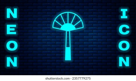 Glowing neon Egyptian fan icon isolated on brick wall background.  Vector