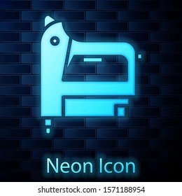 Glowing neon Electric construction stapler icon isolated on brick wall background. Working tool.  Vector Illustration