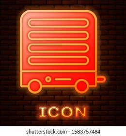 Glowing neon Electric heater icon isolated on brick wall background. Infrared floor heater with remote control. House climate control.  Vector Illustration