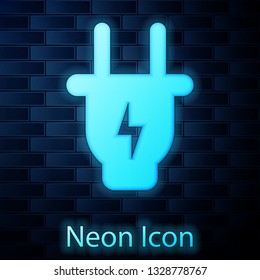 Glowing neon Electric plug icon isolated on brick wall background. Concept of connection and disconnection of the electricity. Vector Illustration