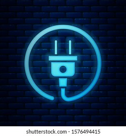 Glowing neon Electric plug icon isolated on brick wall background. Concept of connection and disconnection of the electricity.  Vector Illustration