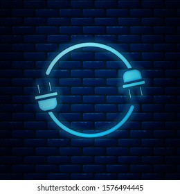 Glowing neon Electric plug icon isolated on brick wall background. Concept of connection and disconnection of the electricity.  Vector Illustration