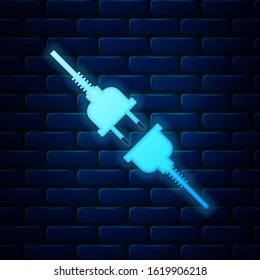 Glowing neon Electric wire plug and socket icon isolated on brick wall background.  Vector Illustration