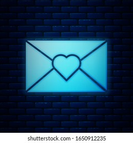 Glowing neon Envelope with Valentine heart icon isolated on brick wall background. Message love. Letter love and romance.  Vector Illustration