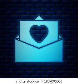 Glowing neon Envelope with Valentine heart icon isolated on brick wall background. Message love. Letter love and romance.  Vector