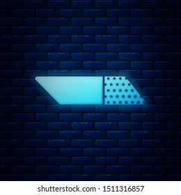 Glowing neon Eraser or rubber icon isolated on brick wall background.  Vector Illustration