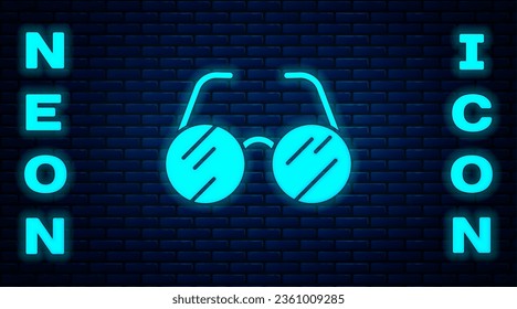 Glowing neon Eyeglasses icon isolated on brick wall background.  Vector