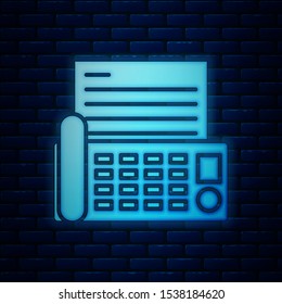 Glowing neon Fax machine icon isolated on brick wall background. Office Telephone.  Vector Illustration