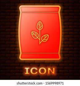 Glowing neon Fertilizer bag icon isolated on brick wall background.  Vector Illustration