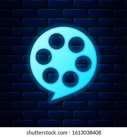 Glowing neon Film reel icon isolated on brick wall background.  Vector Illustration